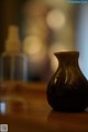 A brown vase sitting on top of a wooden table.