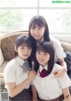 A group of young women in school uniforms posing for a picture.